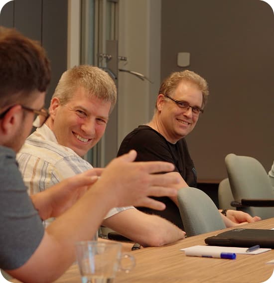 Gradlers sitting at a table smiling