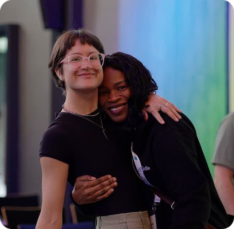 Team members embracing and smiling